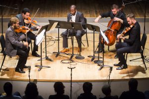 Anthony McGill (center) performs with the Jack Quartet (l to r) Christopher Otto (violin), Ari Streisfeld (violin), Kevin McFarland (cello) and John Pickford Richards (viola) in world premiere of Geoffrey Gordon's Clarinet Quintet at Roulette, 11/20/15. Photo by Chris Lee